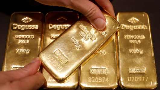 Gold bars and coins representing gold as an investment